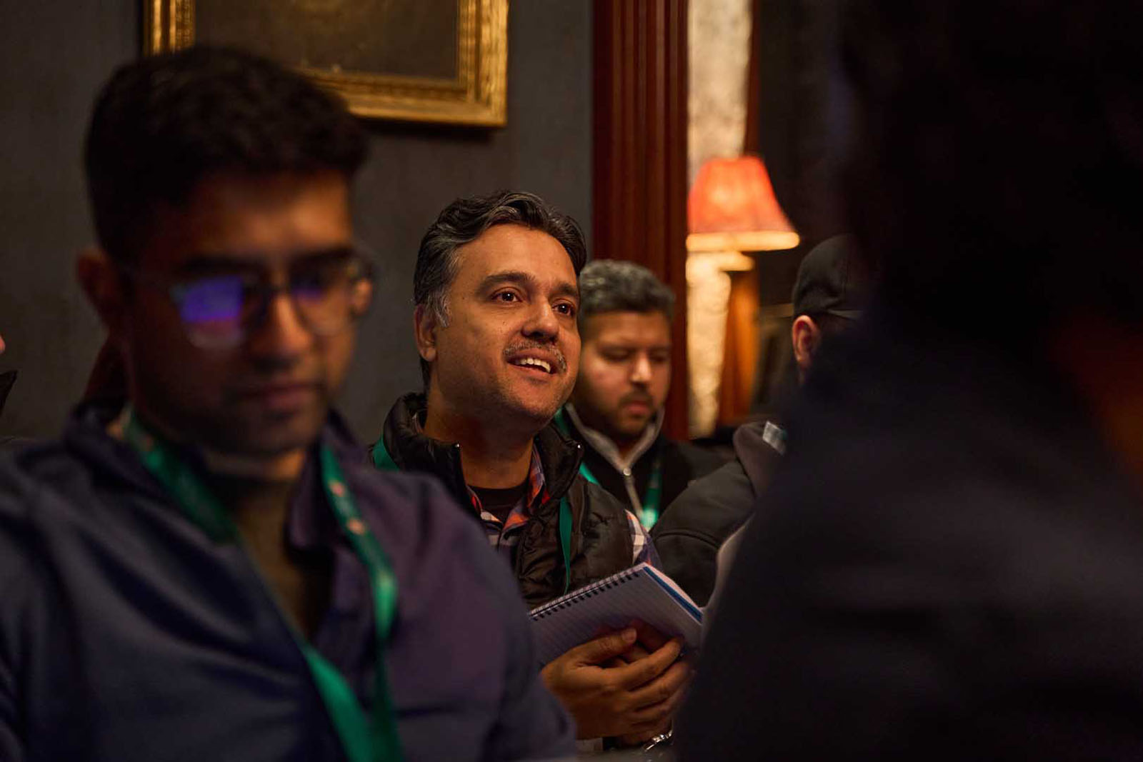 Corporate event attendees listening NYC business networking photography