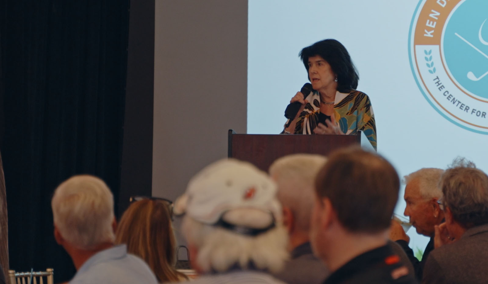 NYC conference female speaker presenting to audience professional photography